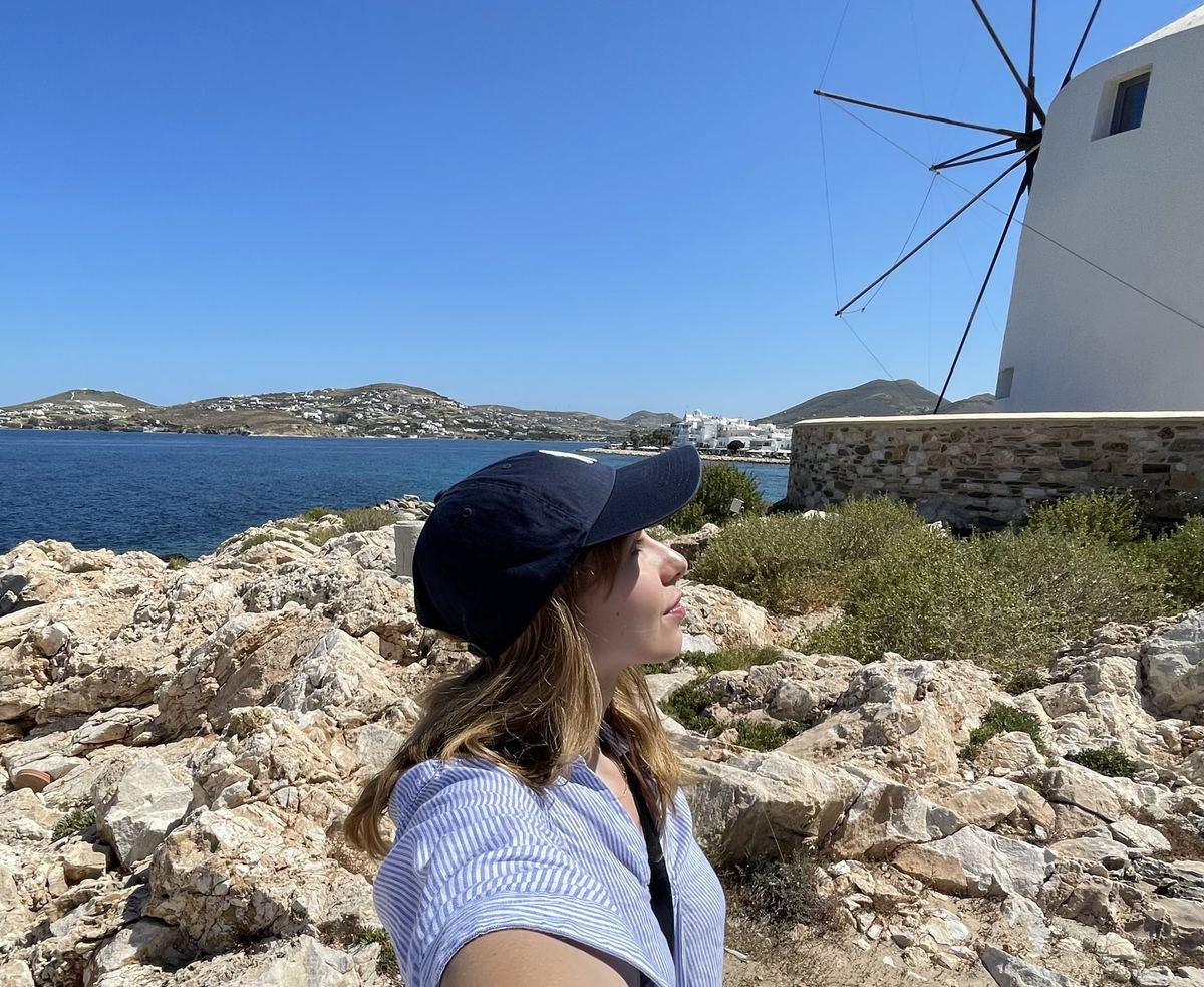 Student by a windmill in the Cyclades